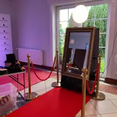 Eleganckie fotolustro na wesele z czerwonym dywanem i rekwizytami do zdjęć. Idealne miejsce na pamiątkowe ujęcia.