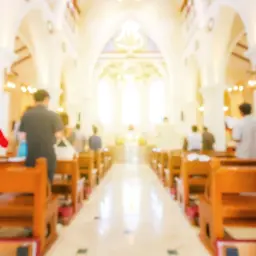 Wnętrze kościoła, ludzie siedzą w ławkach. Zastanawiasz się, ile trwają nauki przedmałżeńskie?